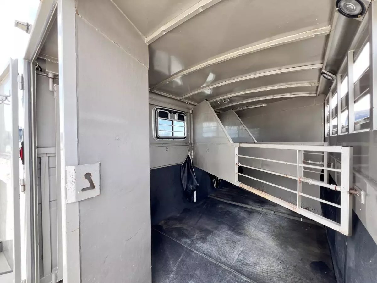 2001 Titan 3 Horse Gooseneck Trailer – Steel, Dressing Room – View of the trailer interior showing horse stall gates and windows
