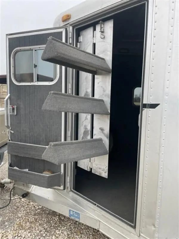 1999 Elite Custom 3 Horse Trailer – Rotating Saddle Rack – Close-up of the swing-out saddle rack attached to the tack room door