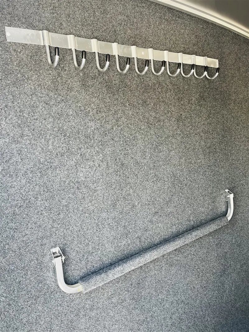 2015 4 Star 2 Horse Bumper Pull – Slant Load, Rear Tack – Interior tack room wall with a row of metal bridle hooks and bar