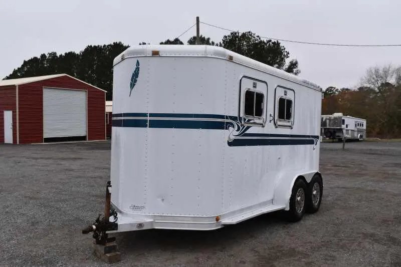 1995 Featherlite 2 Horse Trailer – Aluminum, Dressing Room – Three-quarter front view of the white horse trailer with teal feather logo
