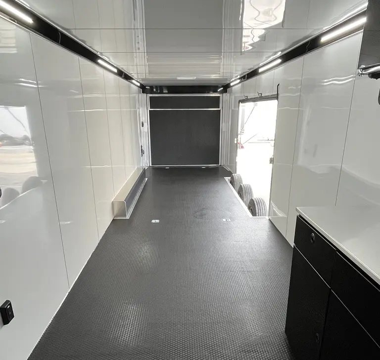 2025 ATC 44 ft Car Hauler – Premium Escape Door – Bright white interior of car hauler looking toward the rear door