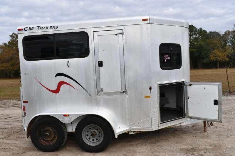 2001 CM Odyssey 2 Horse Trailer – Aluminum Floor – Side profile of the trailer with a small access door open near the front