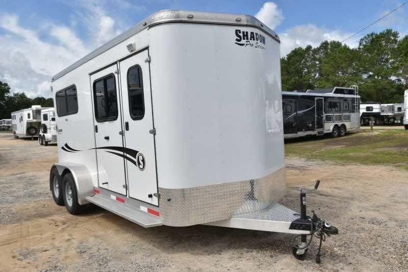 2016 Shadow 2 Horse Trailer – Aluminum, Dressing Room – Front three-quarter view of a white horse trailer with black graphics and hitch