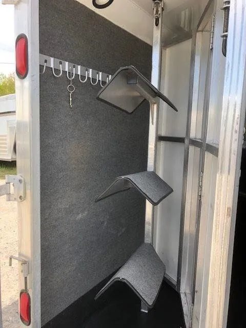 2010 Merhow 3 Horse Bumper Pull Trailer – Rear Ramp – A three-tier saddle rack mounted inside the rear tack storage area