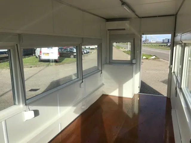 20ft High Cube Observation Office – Shuttered Windows – empty glazed container interior with brown floor and open doorway