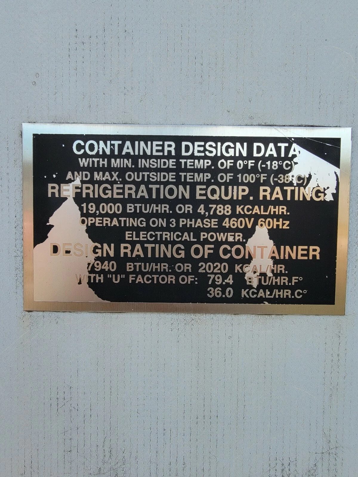 40ft As-Is Insulated Container – Electrical Connection – close-up of worn container refrigeration and electrical specification plate