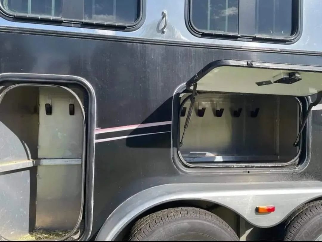 2005 Classic 16 ft 3 Horse Trailer – Dual Tack – Close-up of the side showing exterior storage compartments and a wheel
