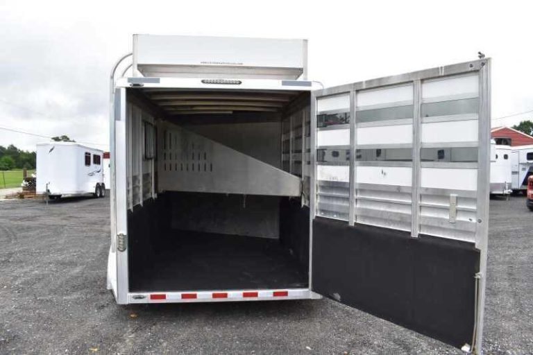 2012 CM 3 Horse Bumper Pull Trailer – Aluminum, Hayrack – Open rear gate revealing the dark rubber floor and horse stalls area