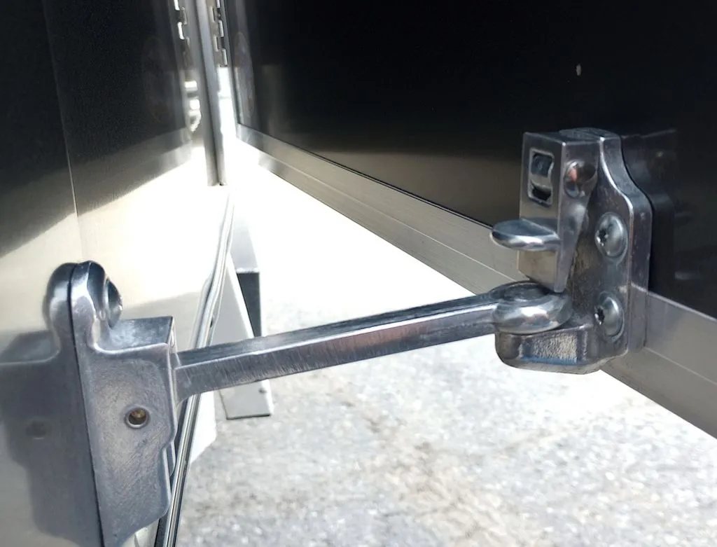 Mission Trailers Aluminum Crossover – Rear Canopy – Close-up of a metal door holder latch on the trailer exterior