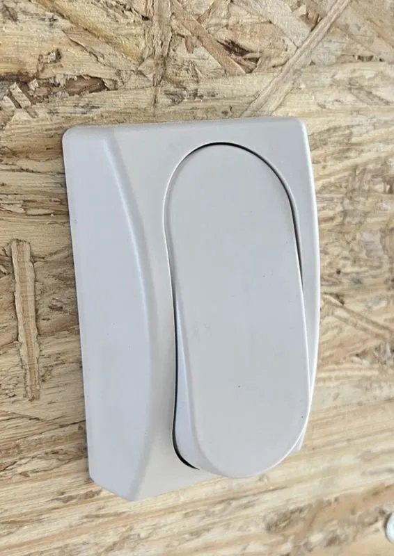 2024 E-Z Hauler 24 ft Trailer – Rear Canopy – Close-up of a white interior light switch mounted on a wood wall