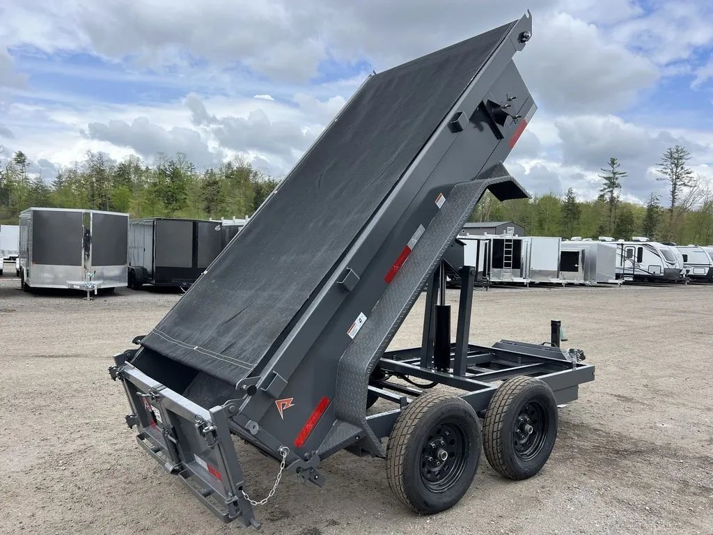 2024 RawMaxx 10 ft Dump Trailer – Shadow Grey – Rear view of the trailer with the bed raised, showing the mesh tarp cover