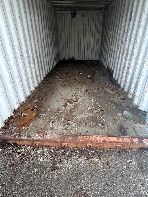 20ft Used Shipping Container – Double Cargo Doors – empty container interior with dirty floor and rusty threshold