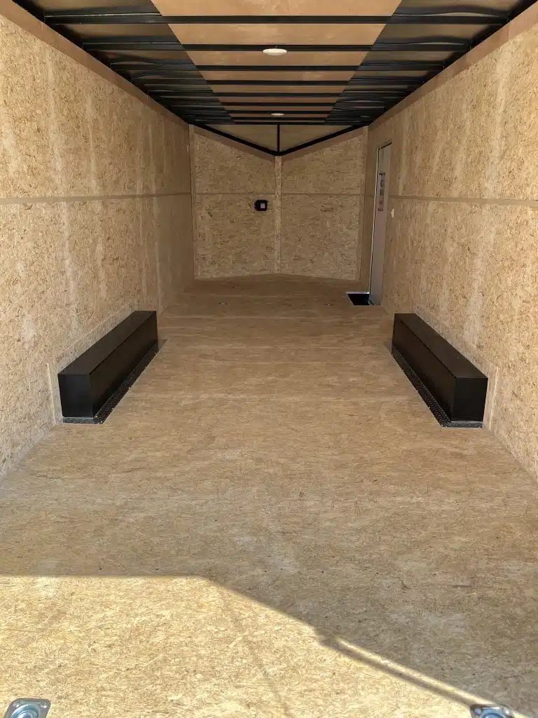 2026 Millennium 24 ft Car Hauler – Silver Hero – Interior view towards the front of the trailer with wood panel walls and floor