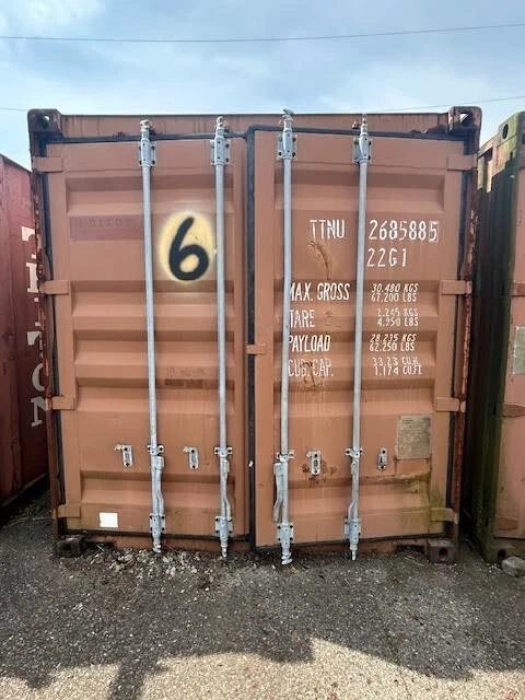20ft Used Shipping Container – Double Cargo Doors – closed cargo doors of a weathered brown shipping container