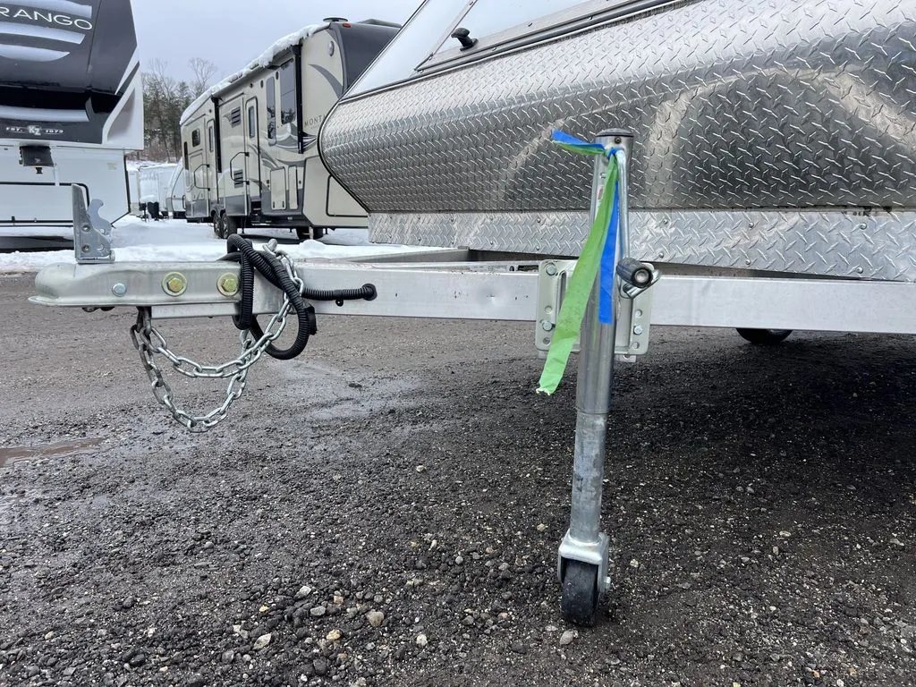 2022 High Country 12 ft Hybrid Trailer – Track Mats – Close-up of the trailer tongue, coupler, safety chains, and jack