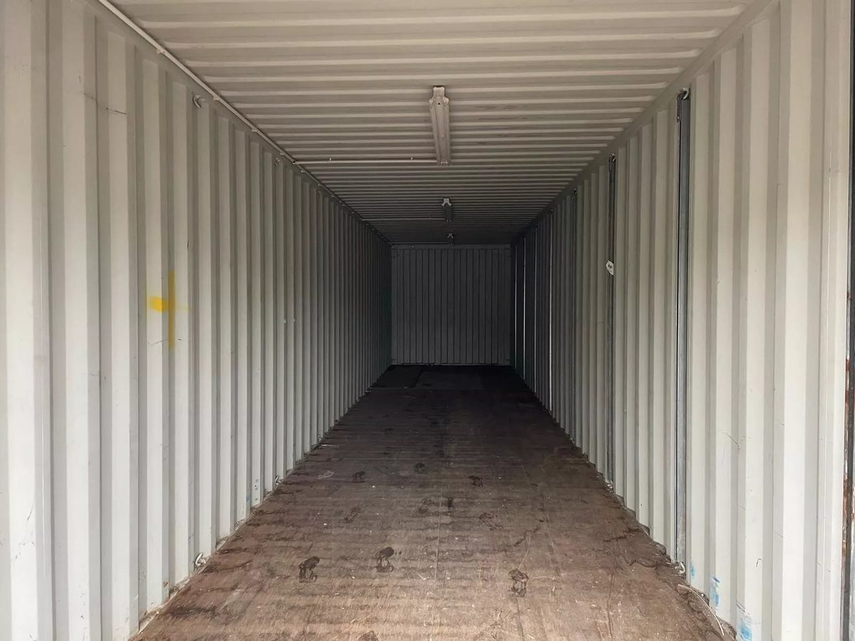40ft Used Shipping Container – Roll-Up Door, Power & Lighting – empty container interior with ceiling lights and electrical conduit