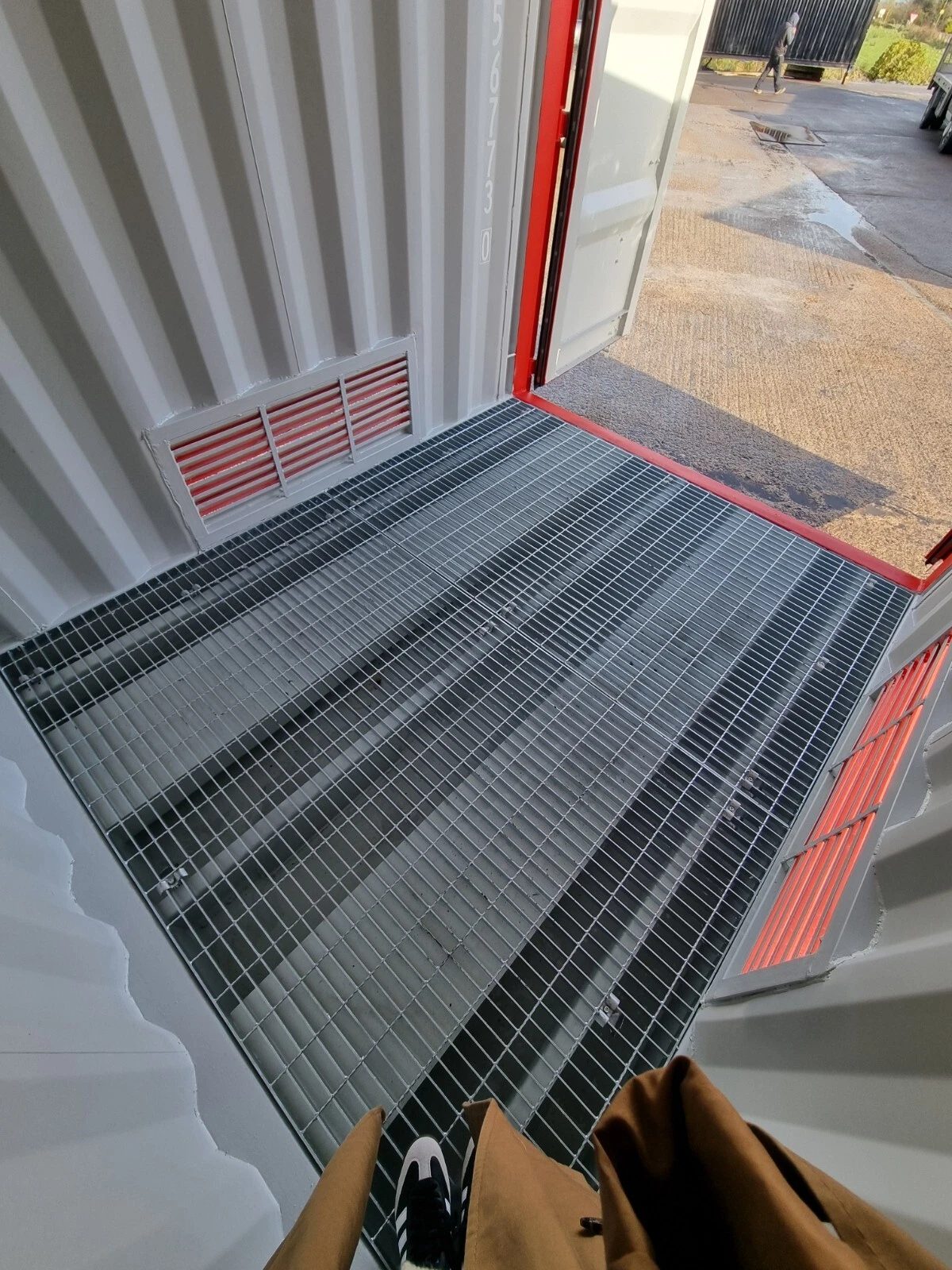 9ft Hazardous Goods Storage Container – Integrated Spill Sump – grated containment floor and wall vents beside open container door