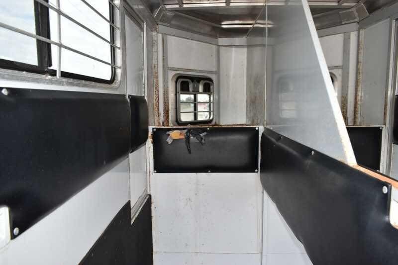 2001 CM Odyssey 2 Horse Trailer – Aluminum Floor – Interior view of the horse stalls with padded dividers and metal bars