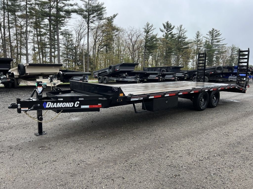 2024 Diamond C 24 ft Deckover – Blackwood Deck – Three-quarter front view of a black equipment trailer parked on gravel