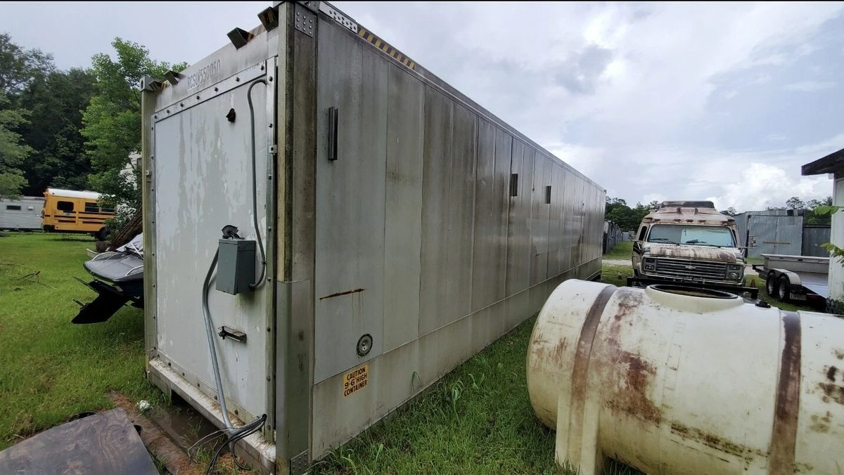 40ft As-Is Insulated Container – Electrical Connection – weathered insulated container exterior with electrical box and conduit