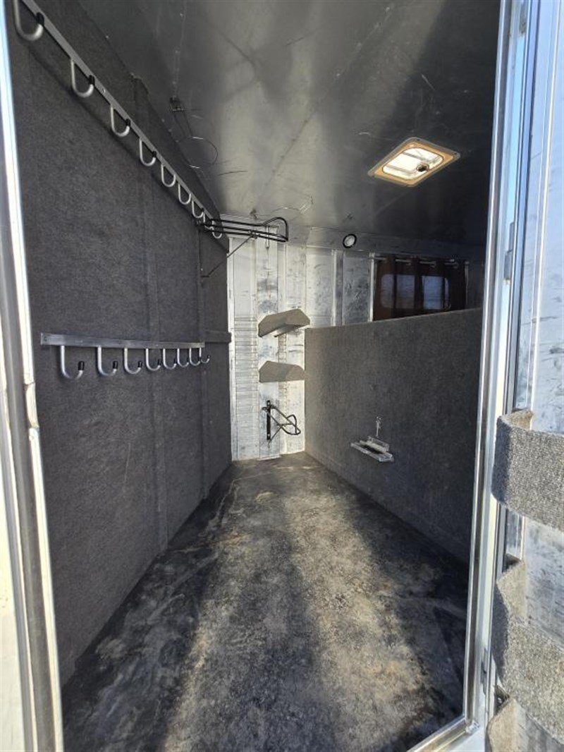 2006 C&C 4 Horse Gooseneck Trailer – Dual Hay Racks – Interior of the tack room featuring carpeted walls and multiple bridle hooks