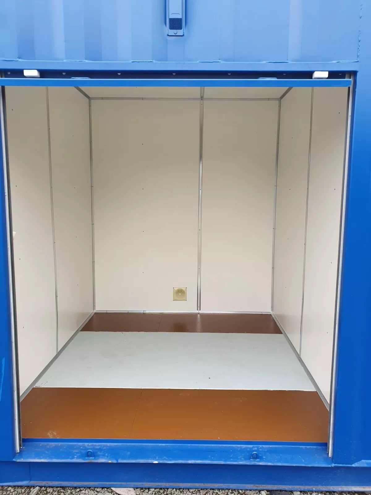 40ft High Cube Storage Container – Insulated, Plywood-Lined – empty lined storage compartment viewed through blue container opening
