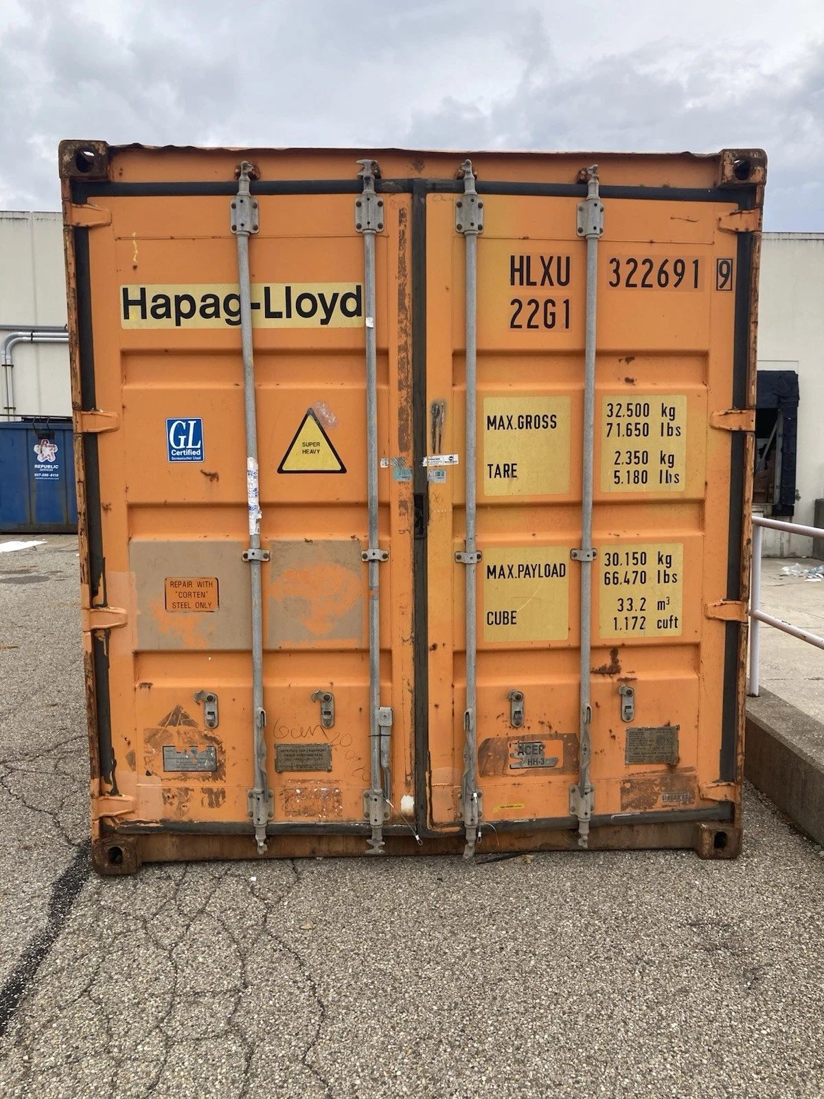 20ft Used Shipping Container – Ground-Level Storage – front view of weathered orange container with cargo doors closed