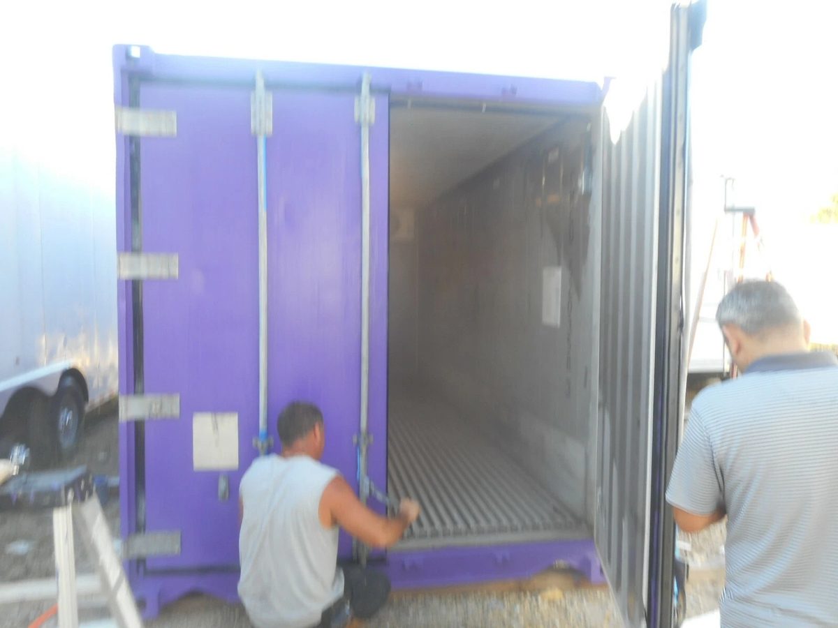 20ft Refurbished Cold Storage Container – Freezer/Cooler – purple refrigerated container with one door open and people outside