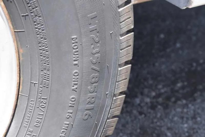 2006 Adam 7302 3 Horse Trailer – Aluminum, Dressing Room – Close-up view of the tire tread and sidewall text