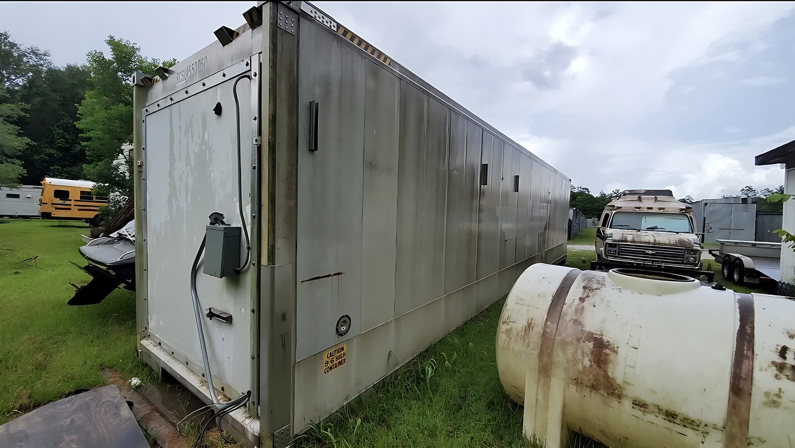 40ft As-Is Insulated Container – Electrical Connection – weathered insulated container exterior with electrical box and conduit