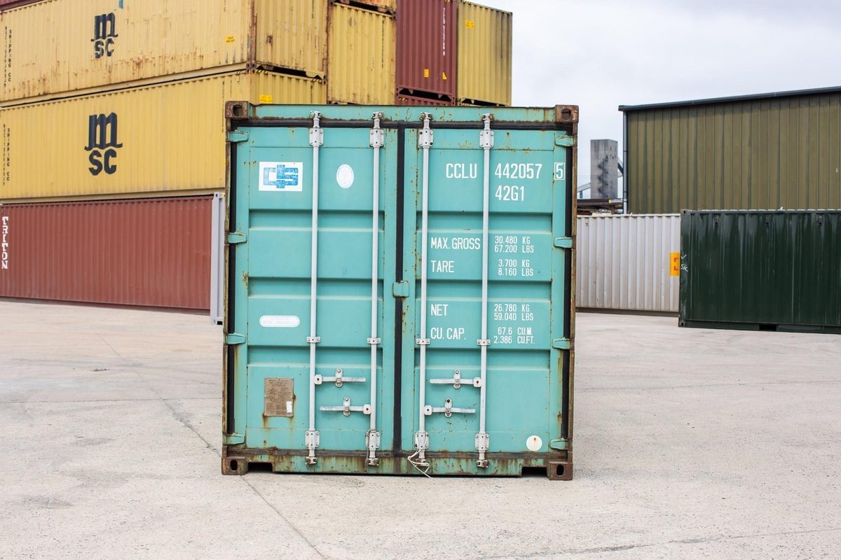 40ft Used Shipping Container – Wind & Watertight Storage – front view of weathered turquoise container with cargo doors closed