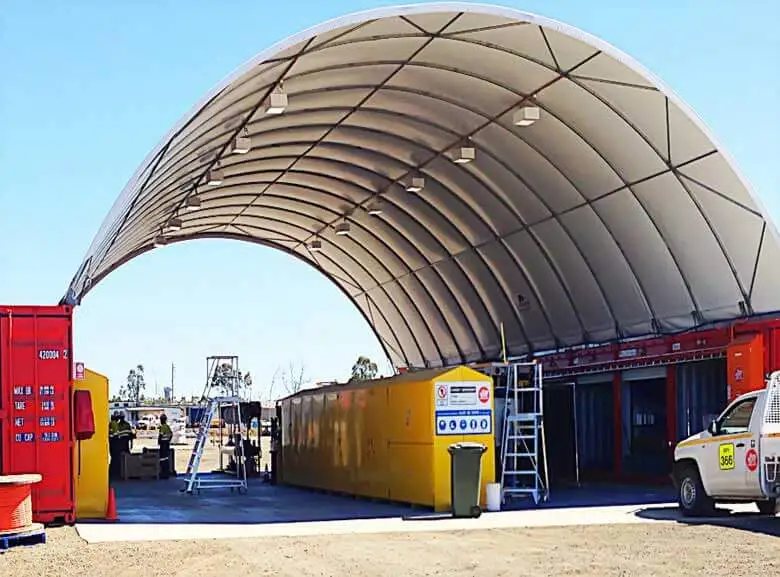 Container Shelter – Domed Tensile Membrane Cover – Underneath a large white arched container shelter showing lighting and storage units