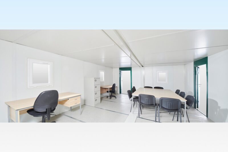 21.3 ft Flat-Pack Office – Side-Linked, White – Wide-angle interior view of the linked office units with desks, chairs and meeting table