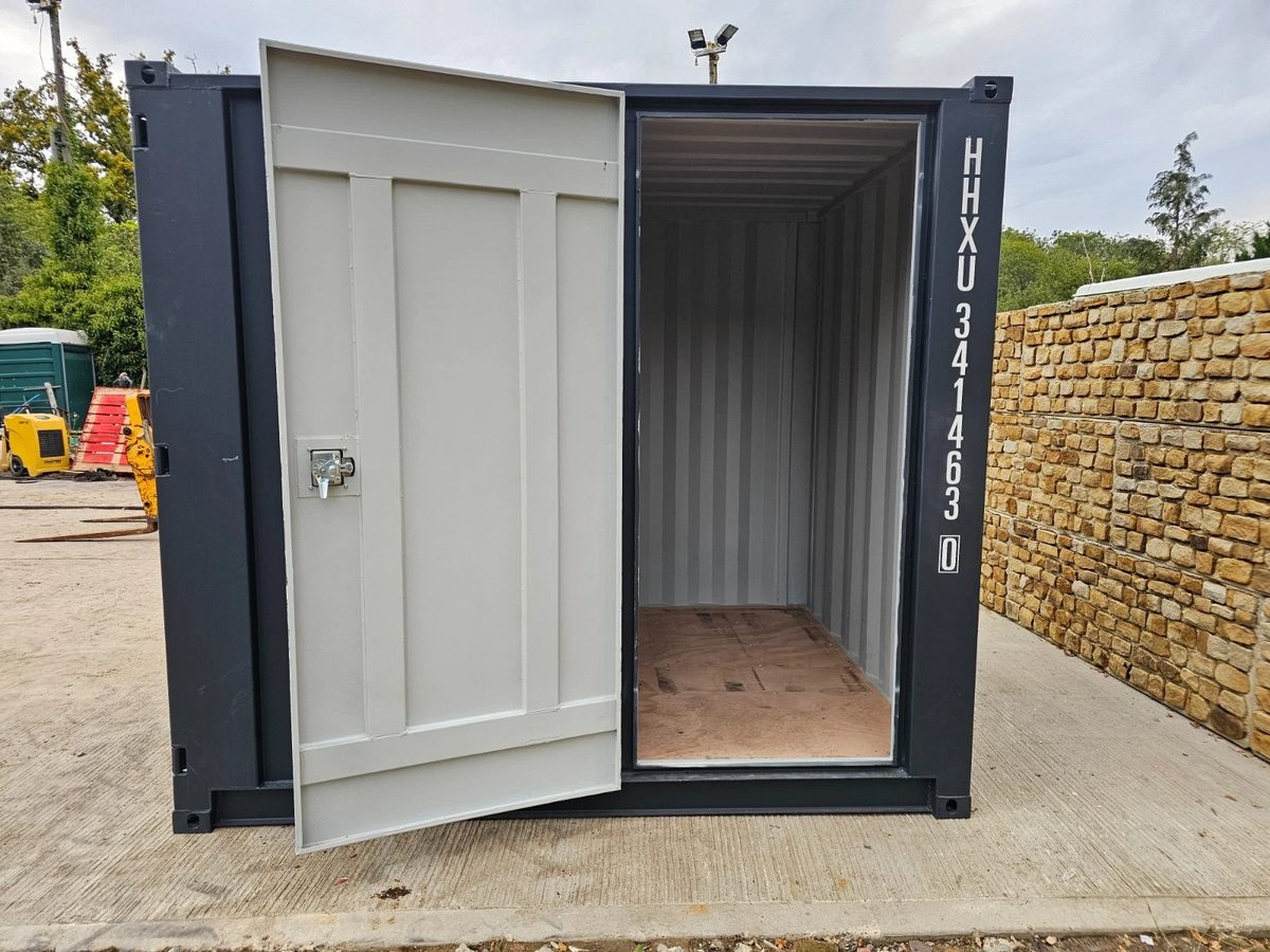 8ft New Shipping Container – Lockbox and Barred Windows – front view of container with open door and empty interior