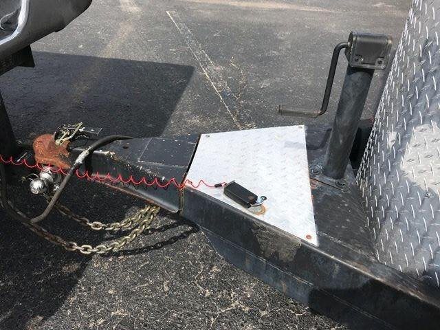 2010 Merhow 2 Horse Slant Trailer – Insulated Roof, Escape Door – Close-up of the trailer hitch, coupler, safety chains, and manual jack