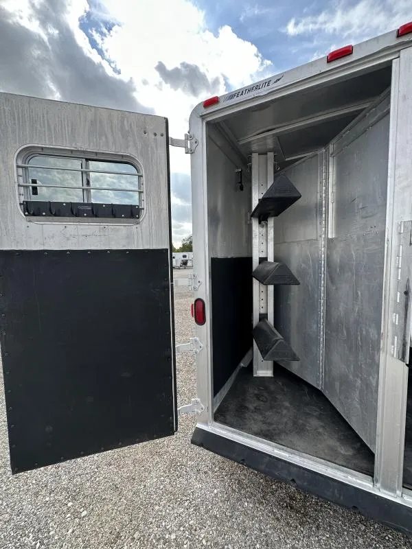 2000 Featherlite 3 Horse Gooseneck – Dressing Room – Rear tack area showing the swing-out saddle rack and open door