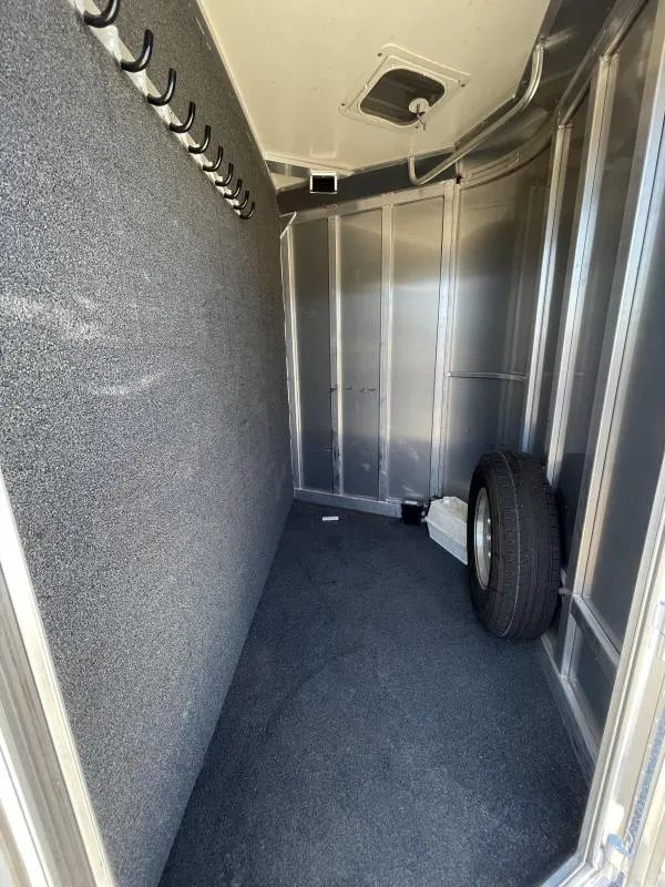 2016 Hart Ultimate 4 Horse Trailer – Champagne, Hay Pod – Wider view of the dressing room interior including a spare tire and vent