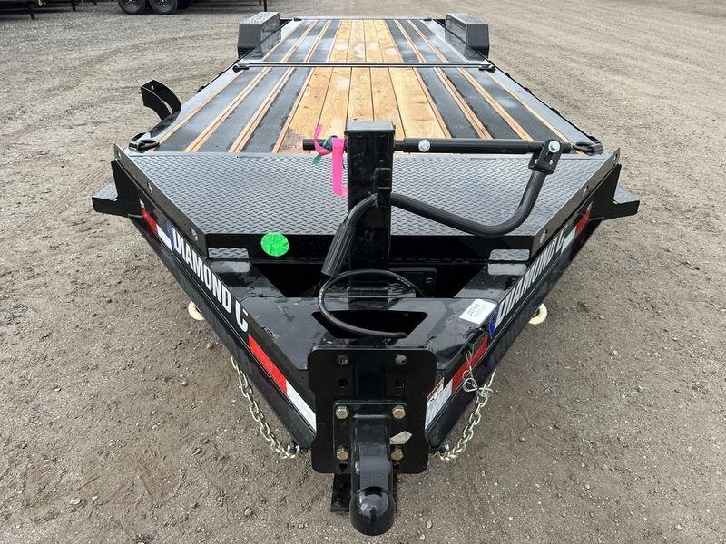 2024 Diamond C 24 ft Tilt Trailer – Spare Mount – Close-up front view of the trailer hitch and wood plank deck surface