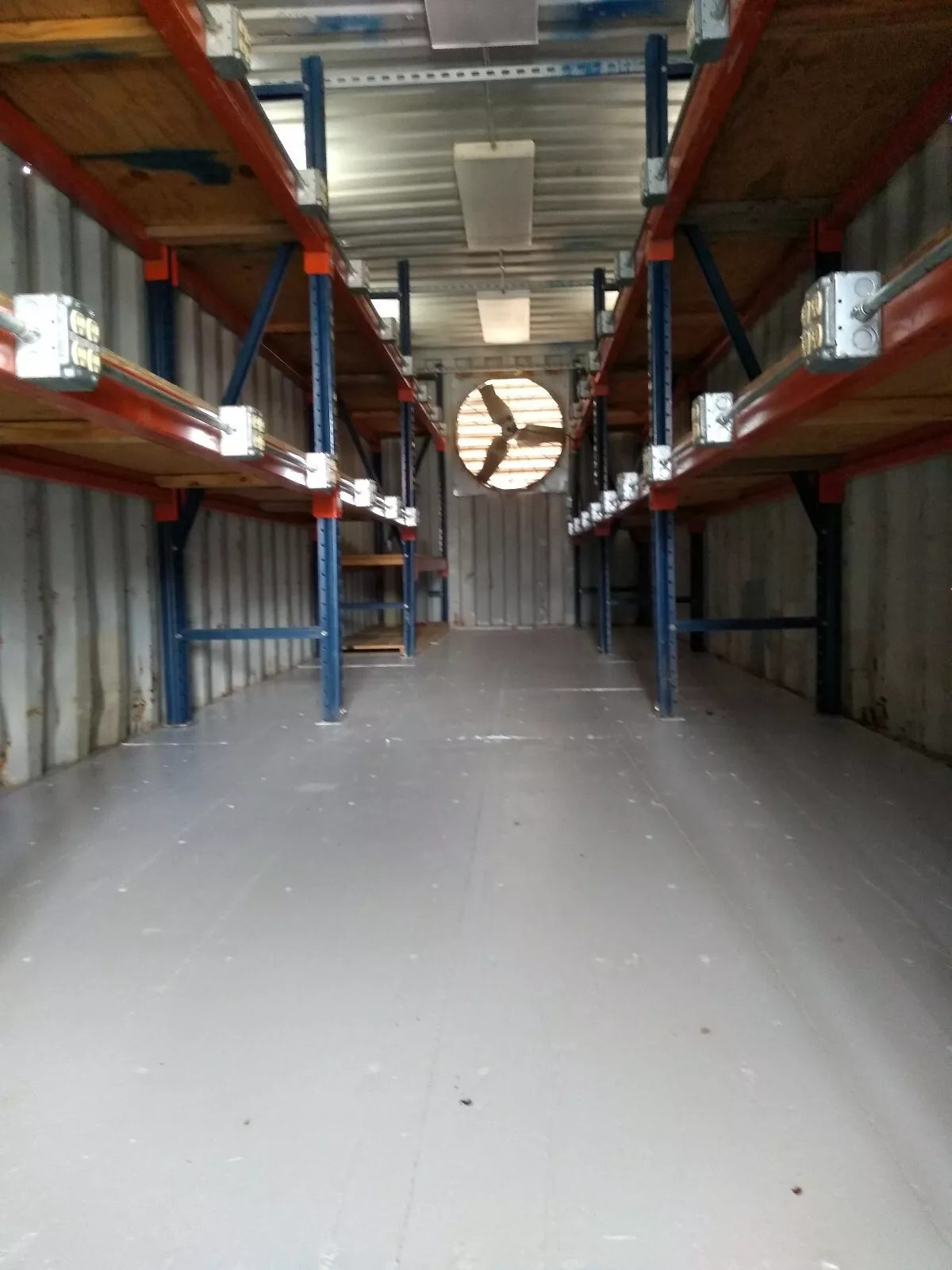 40ft High Cube Container Office – Storage Racking, Side Access – Container storage interior with shelving, electrical outlets and ventilation fan