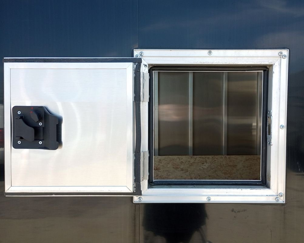 Mission Trailers 22 ft Snowmobile Trailer – 4-Place – A small square access door open on the side of the black trailer