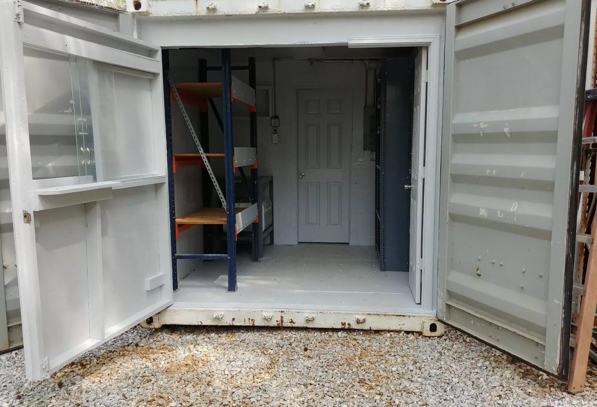 40ft High Cube Container Office – Storage Racking, Side Access – open cargo doors revealing storage racks and interior office door