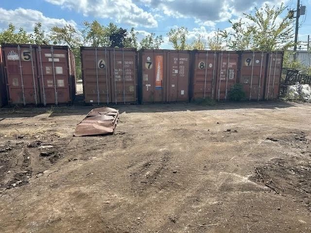 20ft Used Shipping Container – Double Cargo Doors – row of weathered shipping containers with closed cargo doors