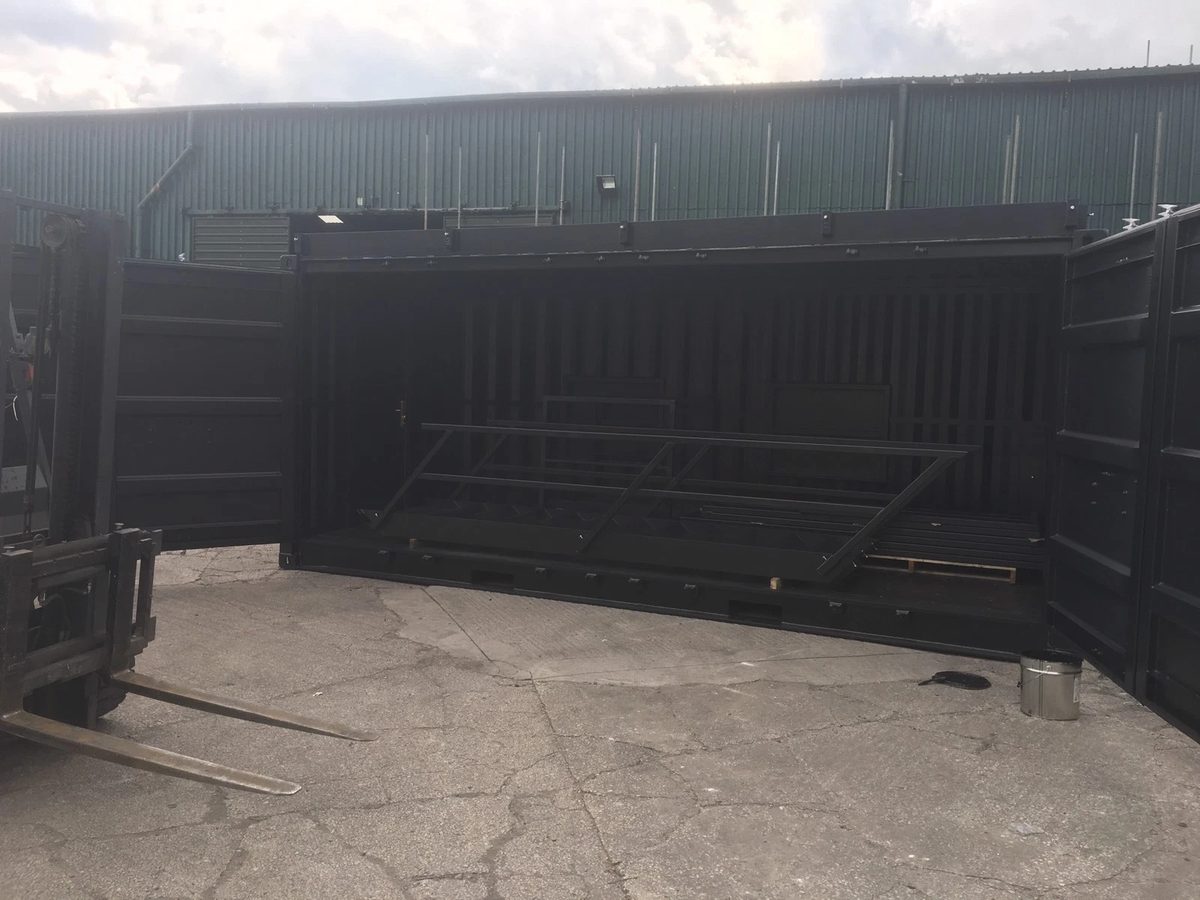 20ft Converted Shipping Container – Serving Hatches and Roof Deck – dark container with side doors open and loose metal frames