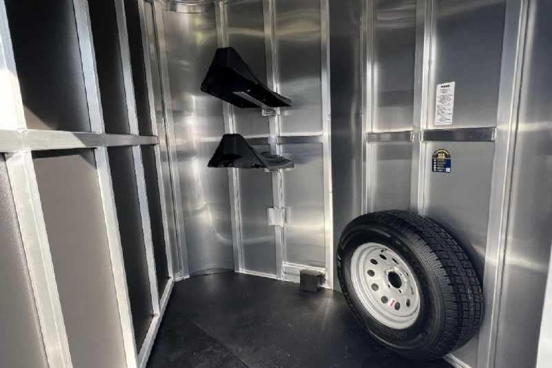 2024 Shadow 2 Horse Bumper Pull Trailer – Aluminum, Dressing Room – Detail view of the tiered saddle racks and spare tire mount