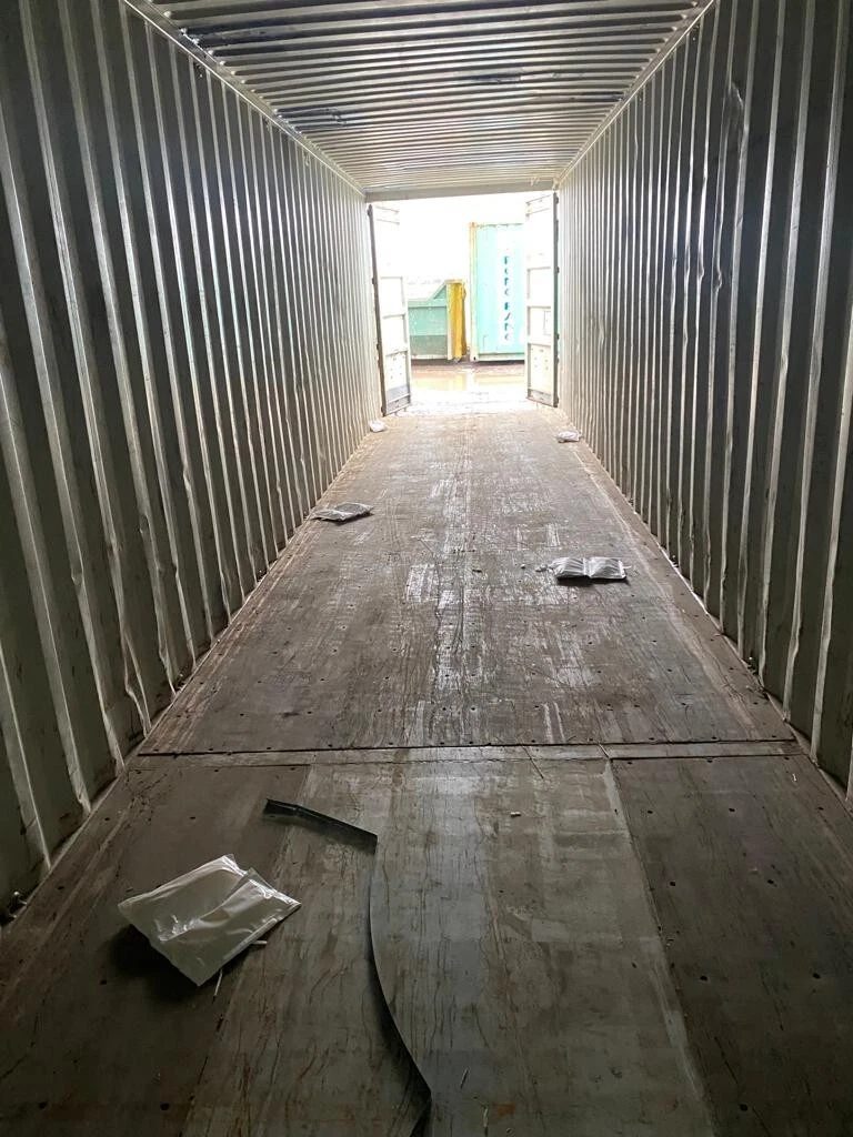 40ft Used Shipping Container – Standard Dry Storage – empty container interior with worn wooden floor and scattered debris