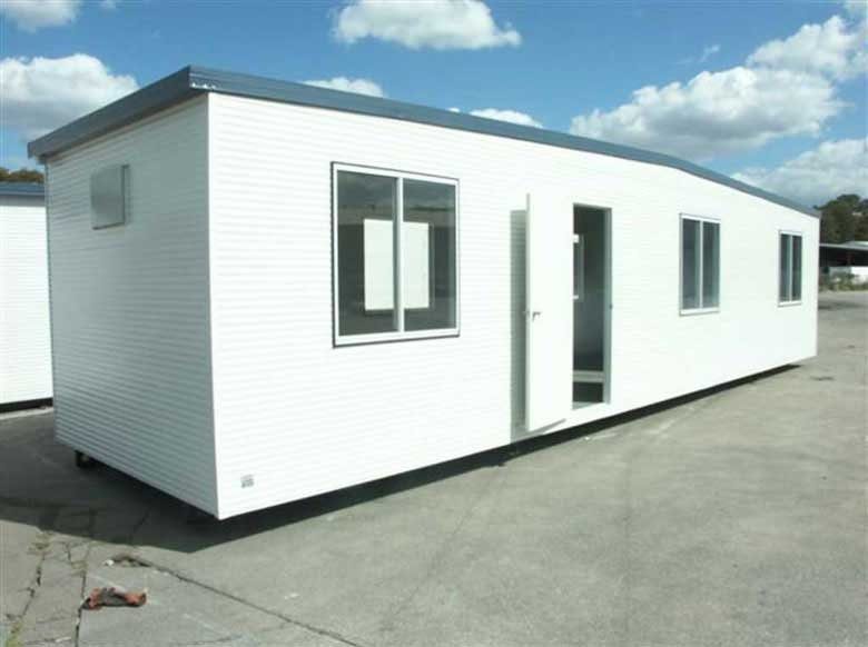 Custom Portable Steel Building – Office, Workshop or Storage – three-quarter exterior of white portable building with open entry door