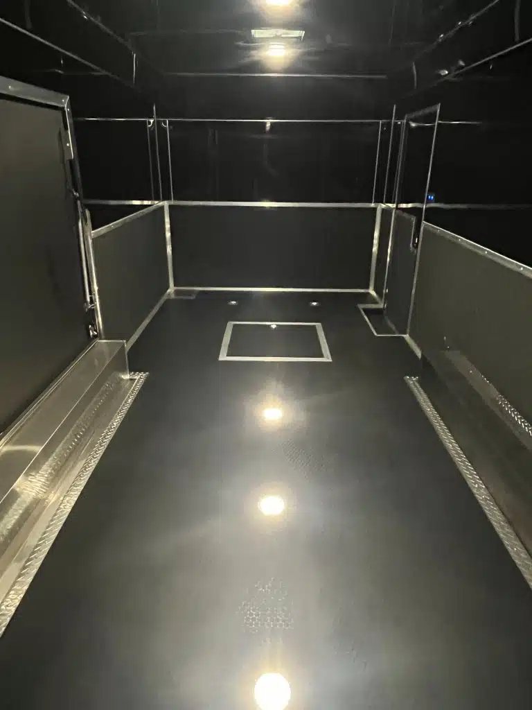 2026 Haulmark 20 ft Car Trailer – Large Escape Door – Clean interior view from the rear looking forward towards the front wall