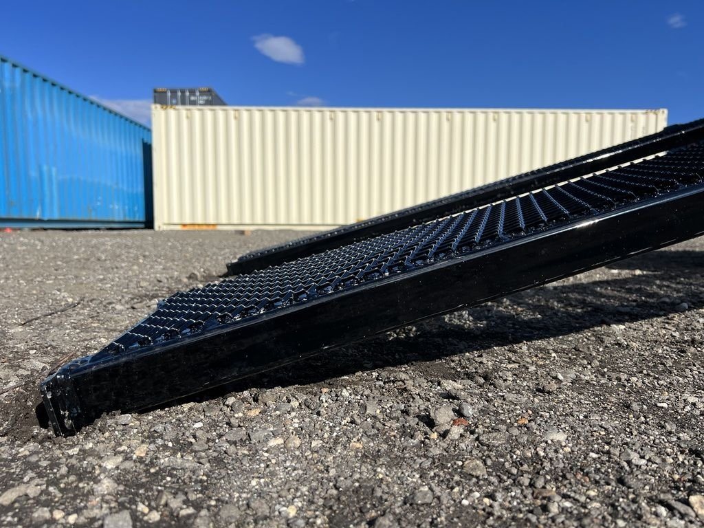 2024 Diamond C 20 ft Deckover – Slide-In Ramps – A detailed close-up of the metal mesh texture on the loading ramps