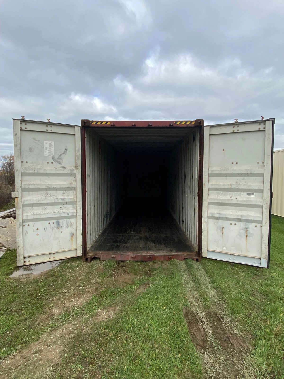 40ft High Cube Used Shipping Container – Lockable Cargo Doors – open cargo doors revealing dark empty container interior