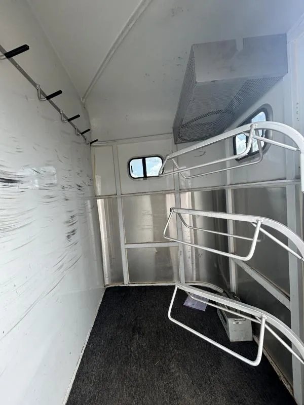 2000 Morgan Built 3 Horse Trailer – Bumper Pull – Inside the tack room area showing tiered saddle racks and bridle hooks
